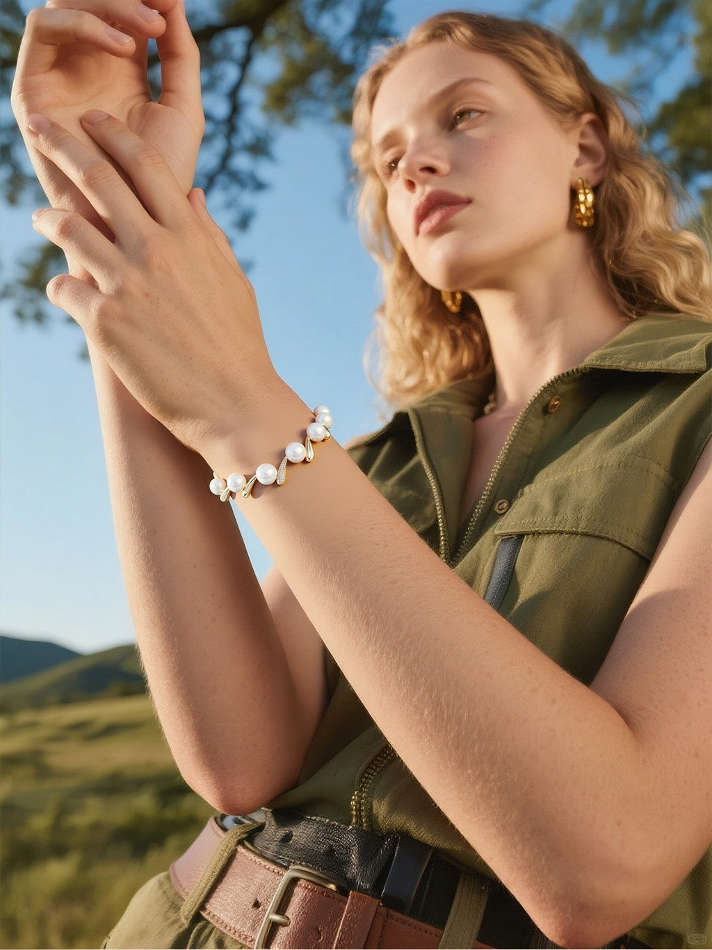 Model wearing BuzzBloom designer pearl bracelet with Australian white shell pearls and diamonds in 14k gold, summer lifestyle fashion scene