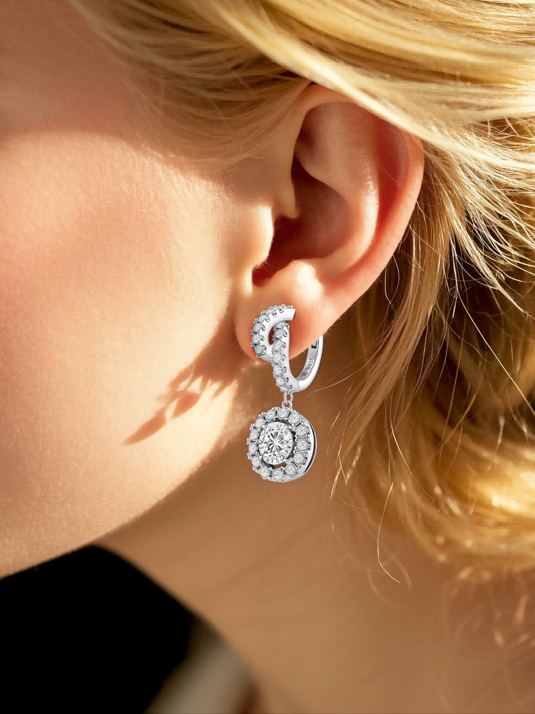 Customer wearing round halo diamond earrings in natural setting, luxury jewelry for modern women
