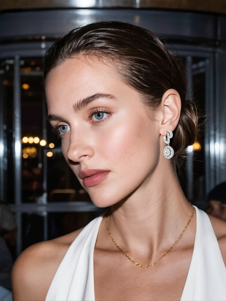 Customer wearing round halo diamond earrings in closeup side profile indoors, luxury BUZZBLOOM fine jewelry