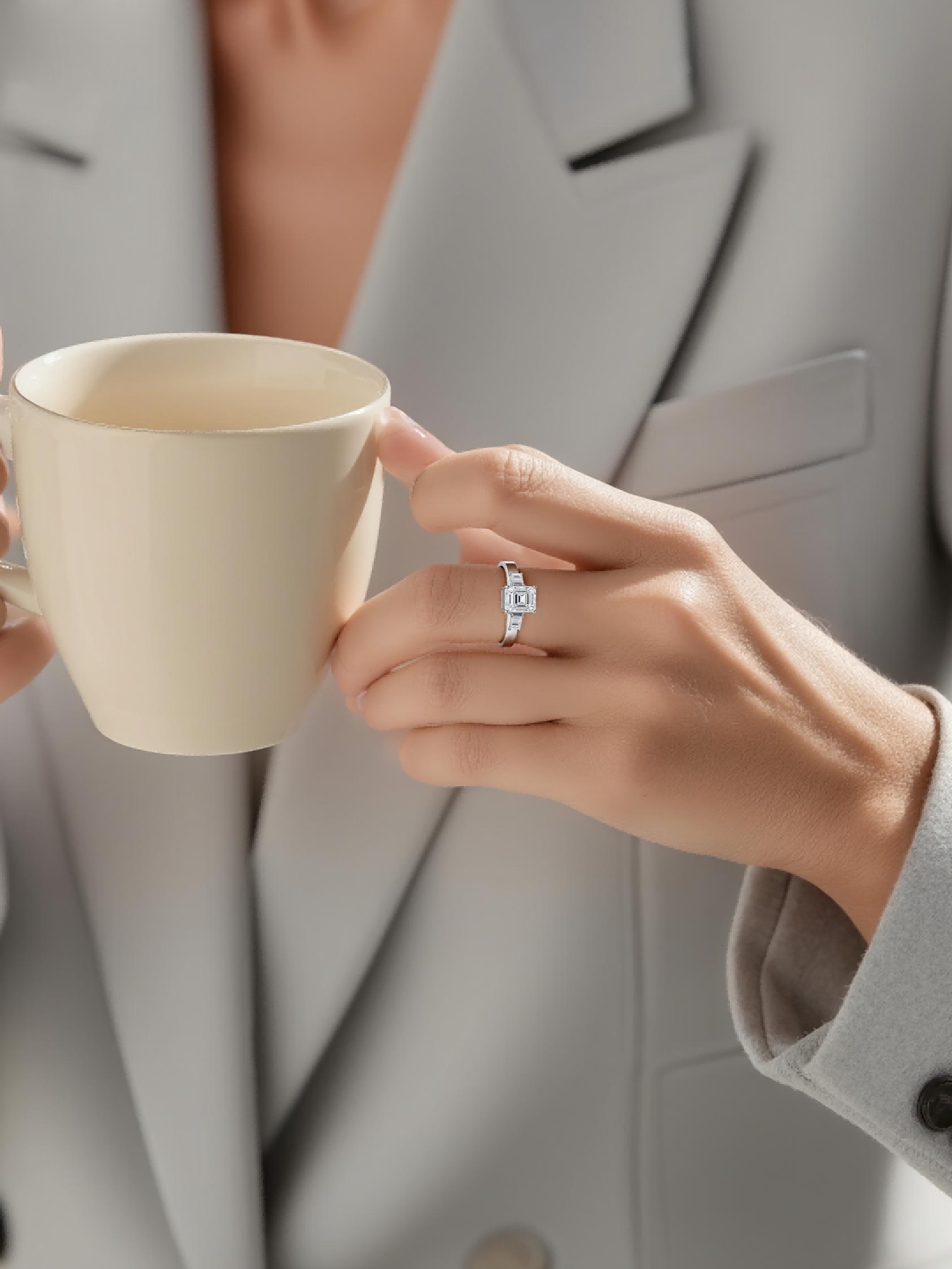 Customer wearing BuzzBloom platinum emerald cut diamond ring with baguette accents in professional office scene for modern women