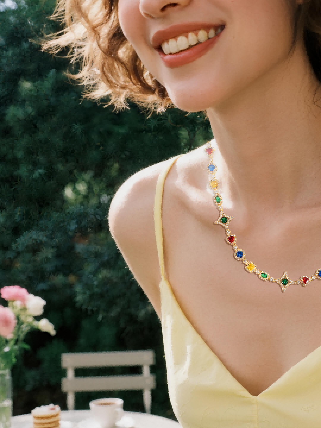 Customer wearing BuzzBloom multicolor gemstone necklace in garden scene, women’s elegant jewelry style