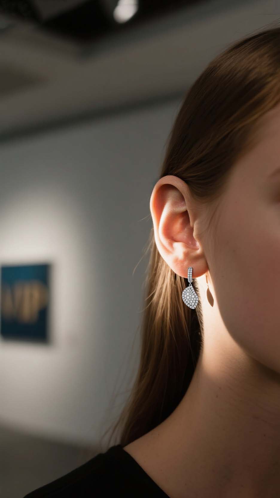 Female model showcasing BuzzBloom leaf design moissanite cluster earrings in gallery scene, bridal and fashion jewelry