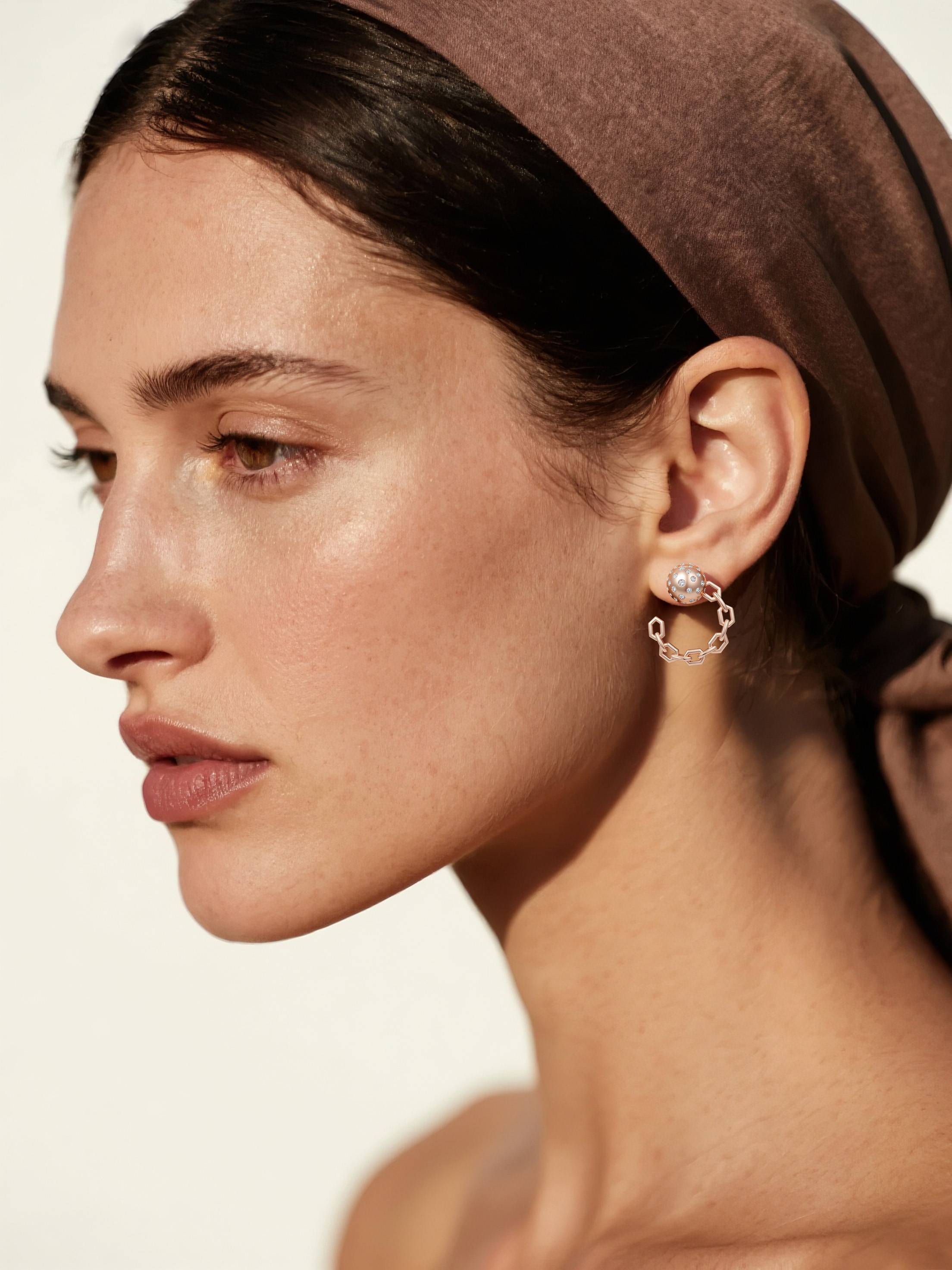 Customer wearing BuzzBloom designer rose gold chain link hoop earrings, side profile portrait, elegant fashion woman