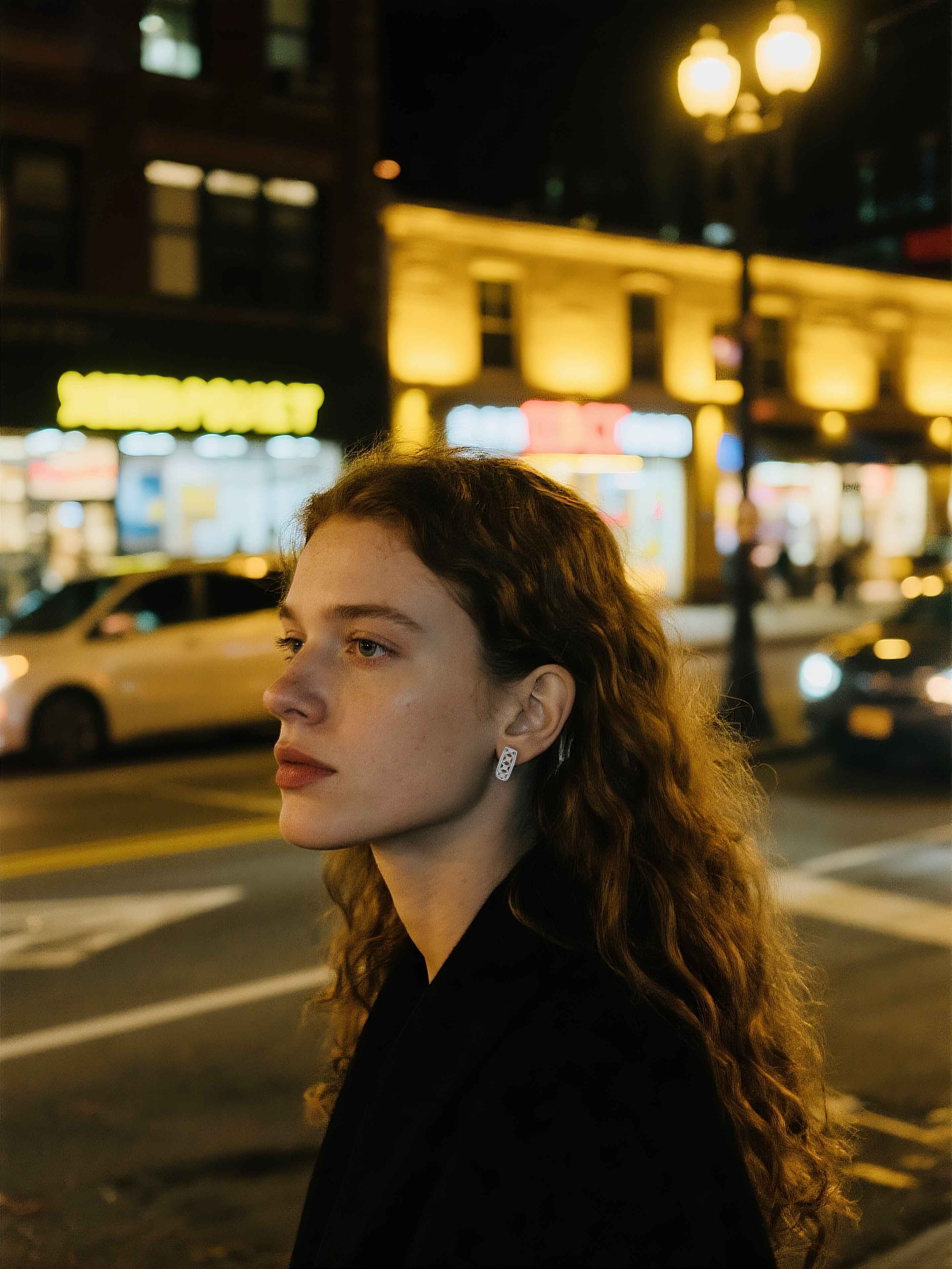 Customer wearing BuzzBloom sterling silver cut-out earrings close-up at night, contemporary women’s jewelry