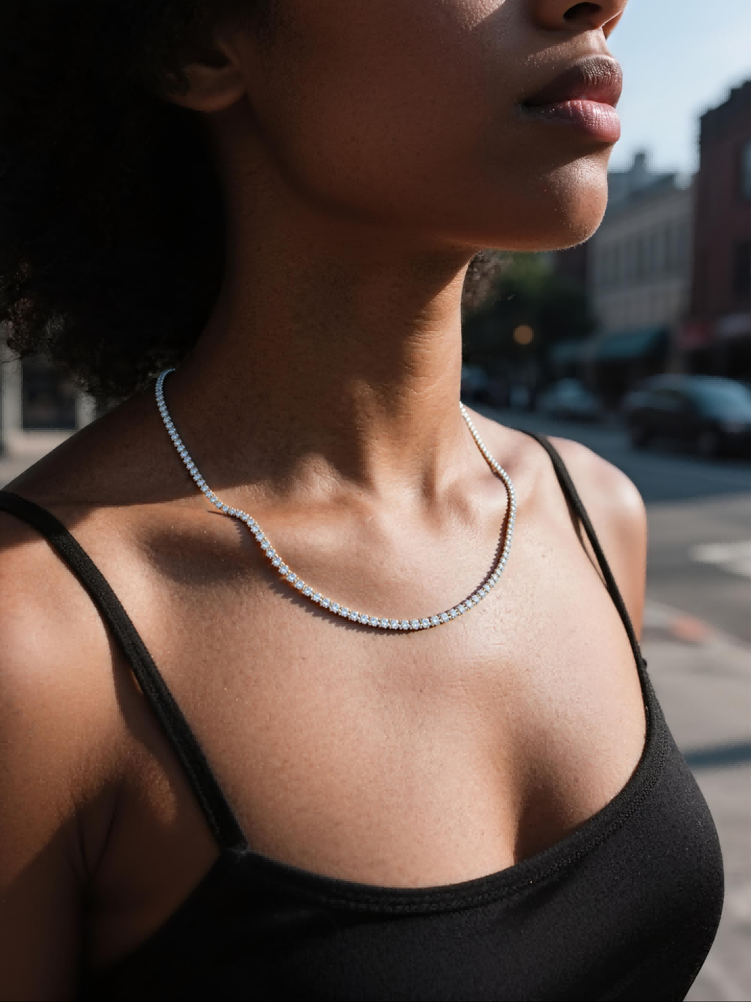 Customer wearing BuzzBloom diamond tennis necklace outdoors, stylish woman street look