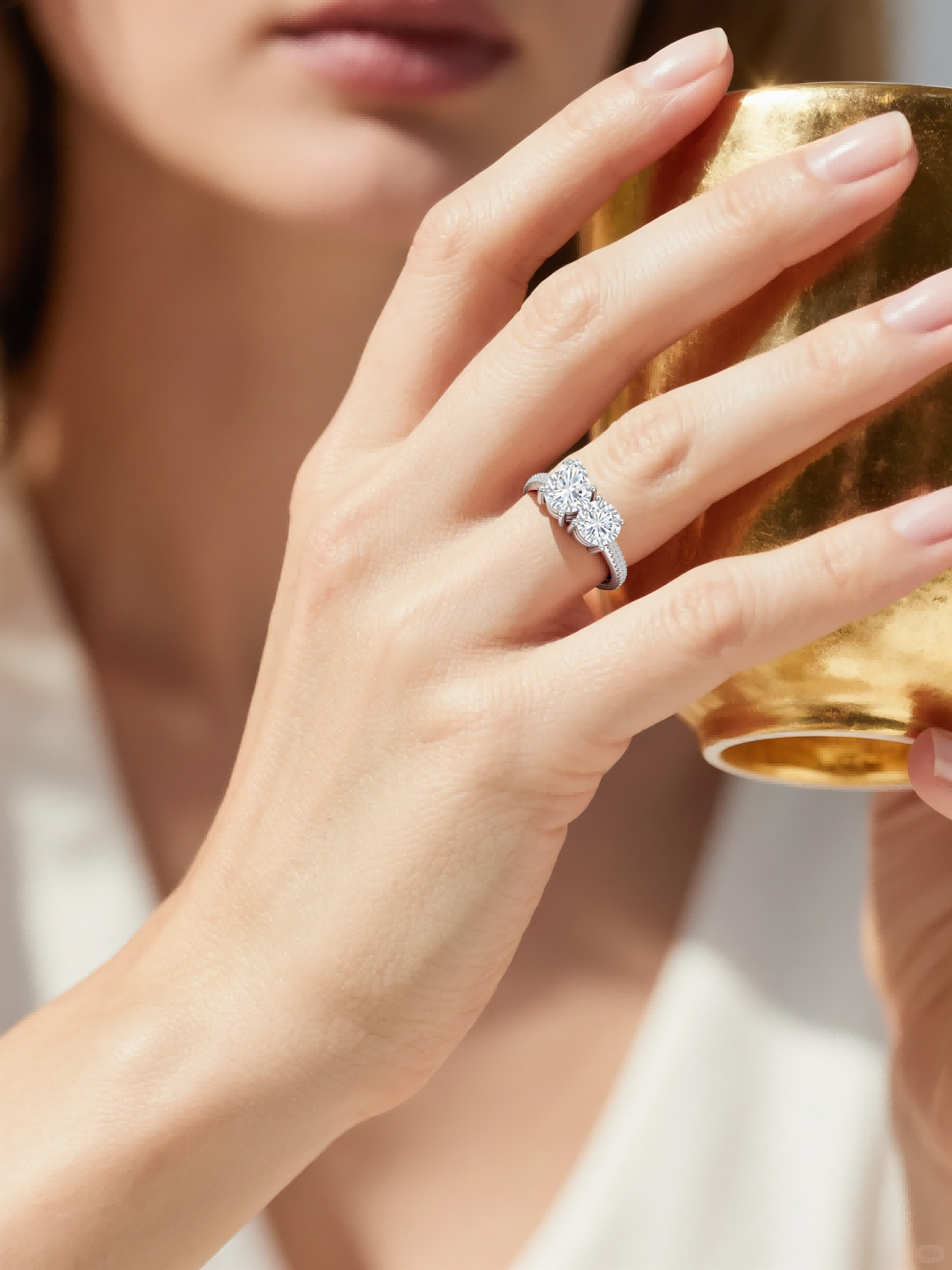 Customer wearing BuzzBloom toi et moi double diamond ring holding a golden cup – luxury lifestyle women’s accessory