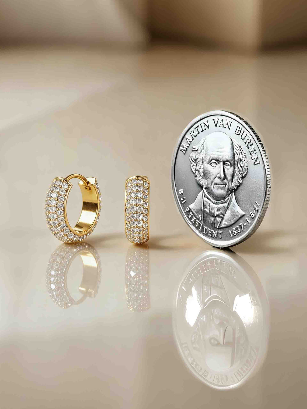 Size comparison of 14K gold diamond hoop earrings with US coin - BuzzBloom NYC 1-inch hoops
