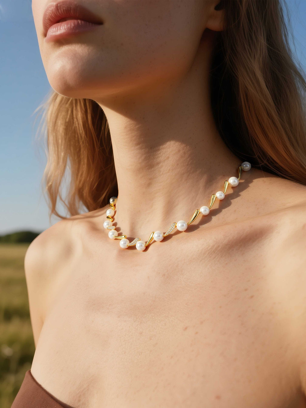 Customer wearing Australian White Shell Pearl necklace with 14K gold and diamond accents outdoors, elegant women’s fine jewelry
