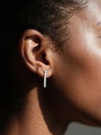 Customer wearing BuzzBloom Moissanite half hoop earrings in indoor lifestyle scene, stylish woman