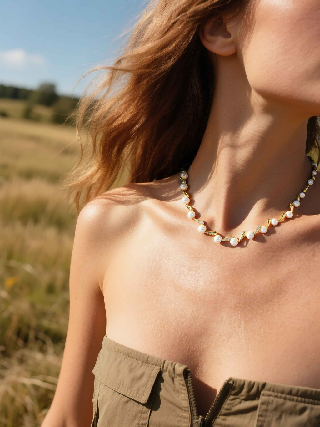 Customer styling designer pearl diamond necklace with gold choker detail in natural sunlight, luxury pearl jewelry for women