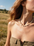 Customer styling designer pearl diamond necklace with gold choker detail in natural sunlight, luxury pearl jewelry for women