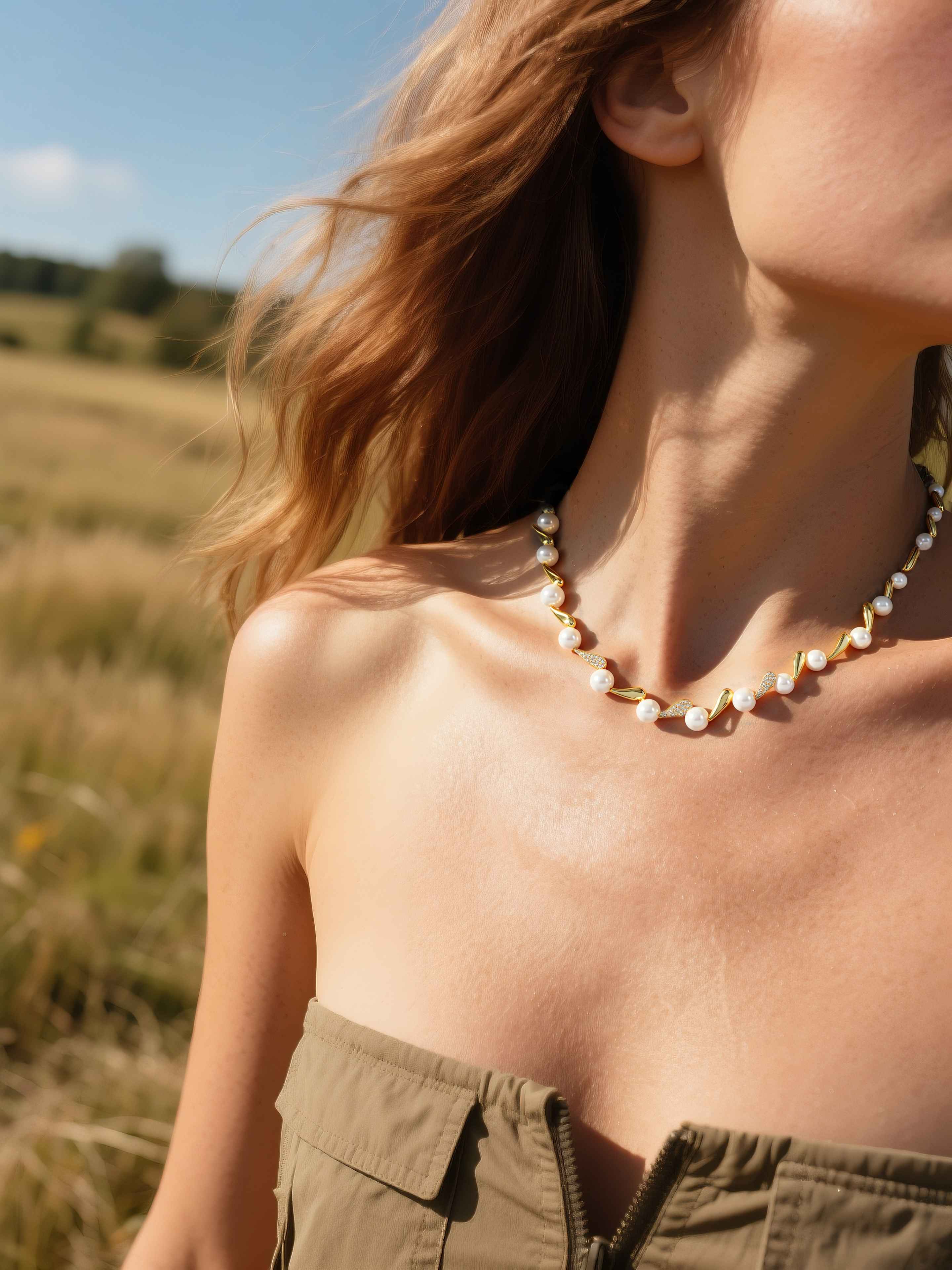 Customer styling designer pearl diamond necklace with gold choker detail in natural sunlight, luxury pearl jewelry for women