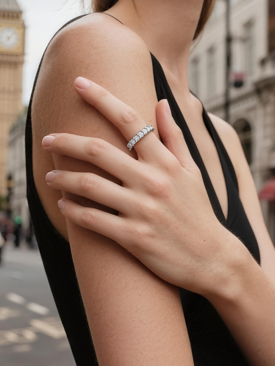 BuzzBloom customer styling infinity diamond band outdoors in urban setting, chic women’s everyday ring