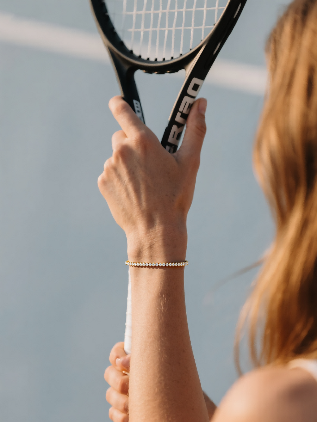 Customer wearing 4mm diamond tennis bracelet 14K gold while playing tennis – stylish women’s jewelry