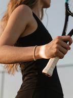 Customer wearing 14K gold diamond tennis bracelet on court – active lifestyle jewelry for women