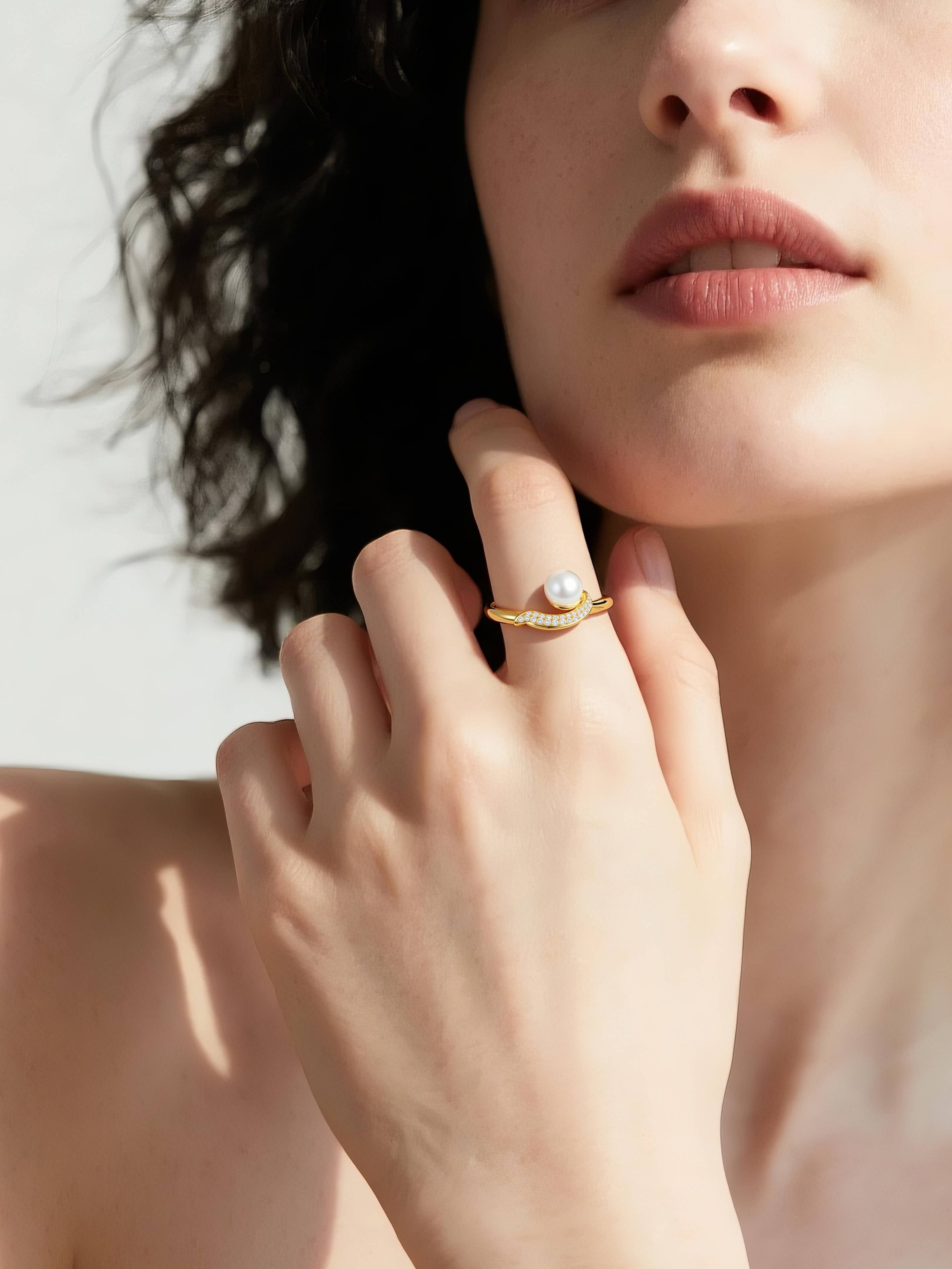 Female model wearing BuzzBloom Australian white shell pearl ring in 14k gold with diamond pavé, elegant jewelry close-up for women