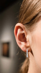Customer wearing BuzzBloom silver hoop moissanite earrings with light reflection scene, elegant women jewelry