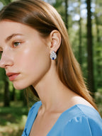 BuzzBloom customer wearing sapphire stud earrings in outdoor daylight, elegant women’s jewelry style
