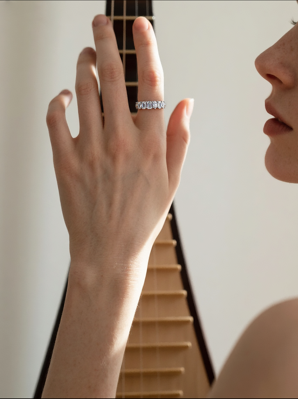 Customer wearing BuzzBloom diamond ring band for women while playing instrument, modern lifestyle jewelry