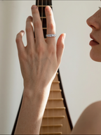 Customer wearing BuzzBloom diamond ring band for women while playing instrument, modern lifestyle jewelry