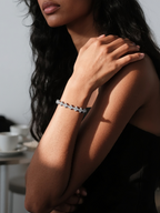 Customer wearing BuzzBloom diamond tennis bracelet in 14K white gold, elegant lifestyle close-up for women’s fine jewelry