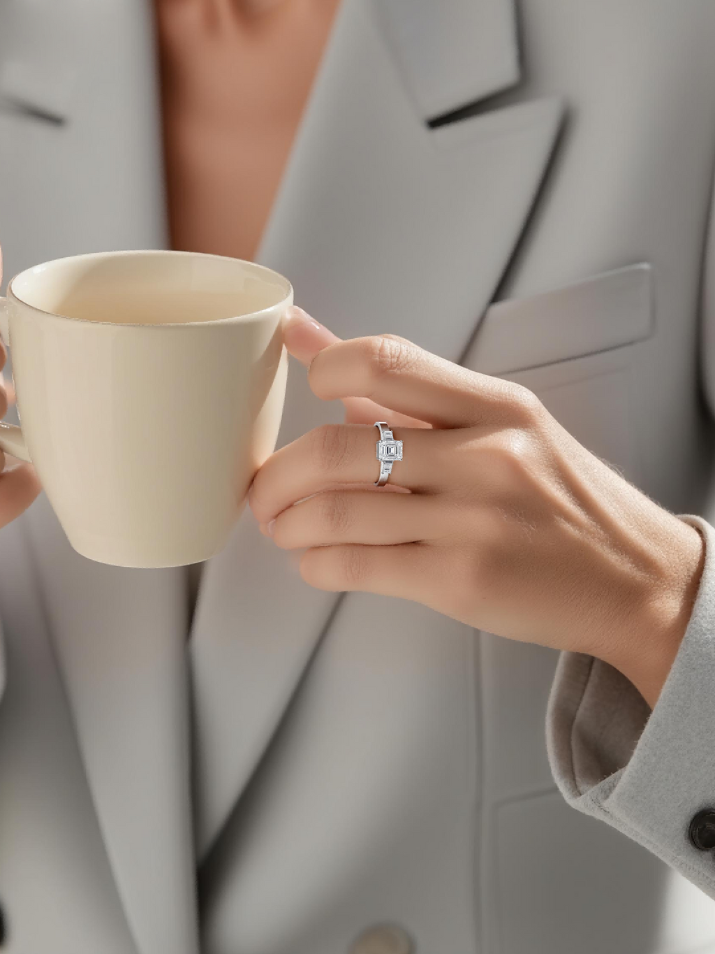 Customer wearing BuzzBloom platinum emerald cut diamond ring with baguette accents in professional office scene for modern women