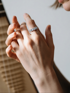 Customer wearing BuzzBloom eternity wedding band ring in natural light, women’s fine jewelry style