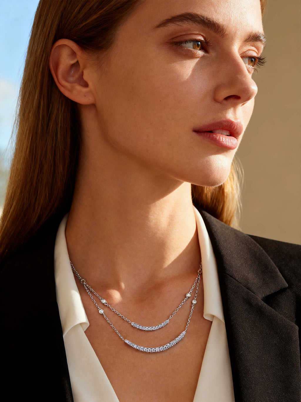 BuzzBloom customer showcasing two-strand crystal necklace outdoors in daylight, elegant layering jewelry for women