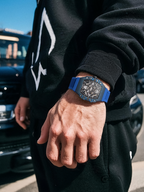 Customer wearing BuzzBloom men’s skeleton watch with blue strap while skateboarding – urban streetwear style