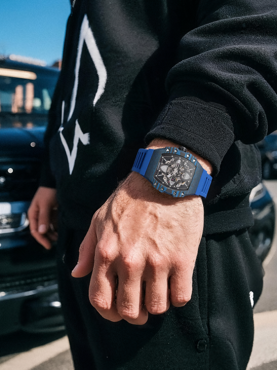 Customer wearing BuzzBloom men’s skeleton watch with blue strap while skateboarding – urban streetwear style