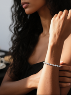 Customer wearing BuzzBloom elegant 14K gold diamond tennis bracelet, lifestyle indoor café scene, women’s fine jewelry