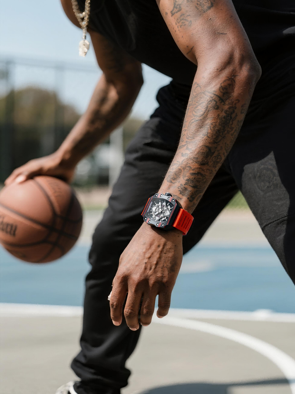 Customer wearing BuzzBloom luxury men’s watch with orange strap while playing basketball, stylish sports scene for men