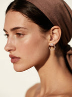 Customer wearing BuzzBloom designer rose gold chain link hoop earrings, side profile portrait, elegant fashion woman