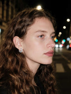 Customer wearing BuzzBloom silver lattice earrings at night street scene, modern fashion style for women