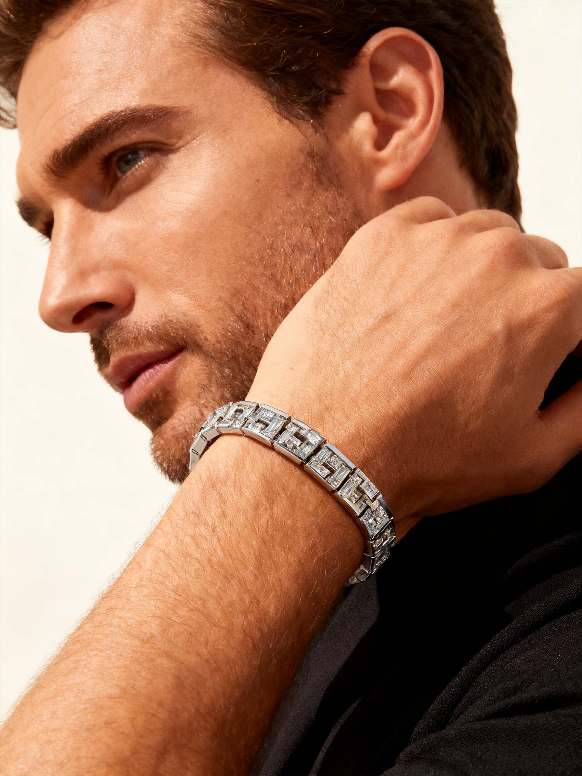 BuzzBloom customer showing BuzzBloom structured sparkle bracelet in lifestyle scene, men’s jewelry focus