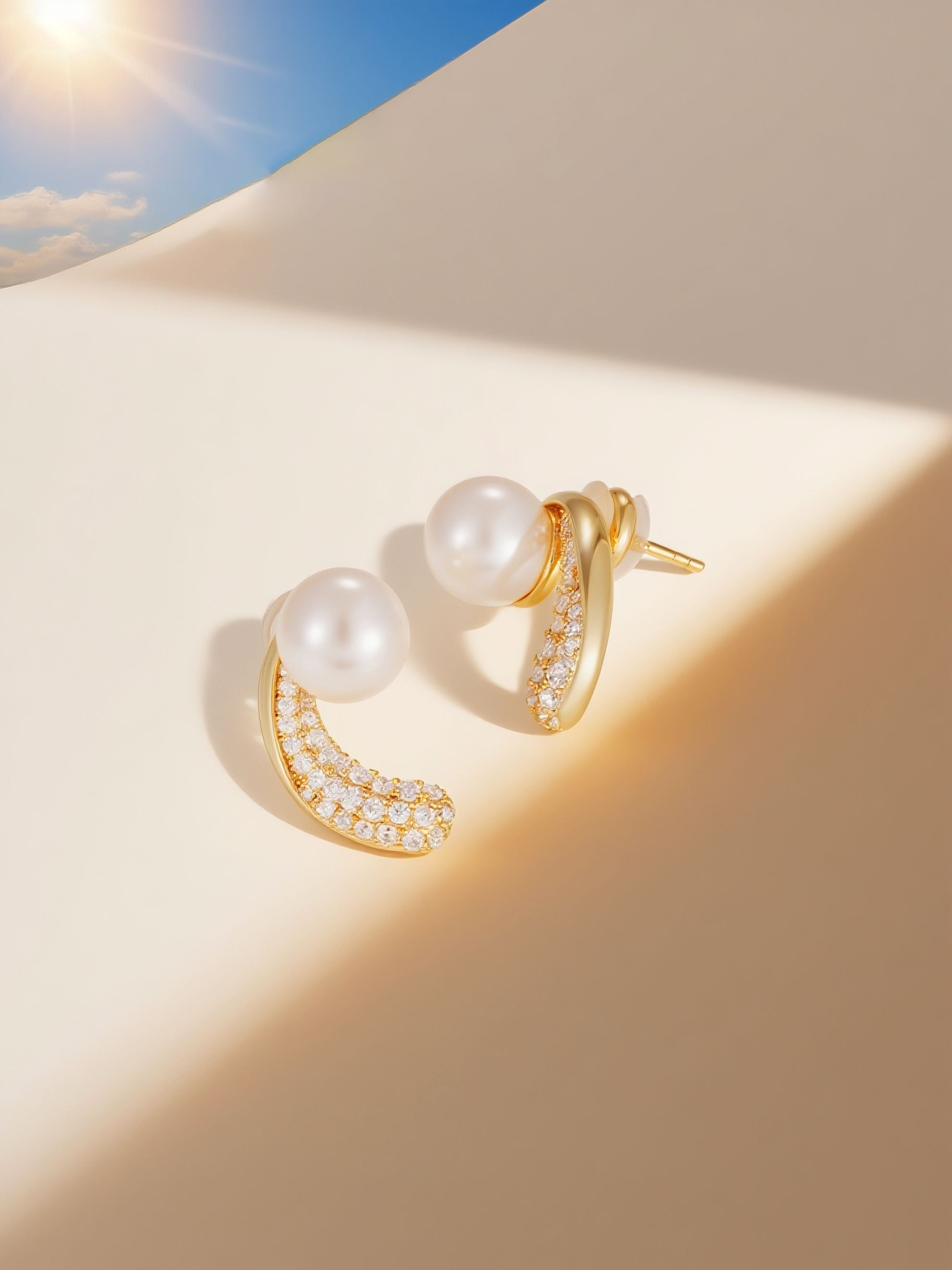 Own Your Bloom Australian white shell pearl 14K diamond stud earrings on mirror with sky reflection, Seattle USA.