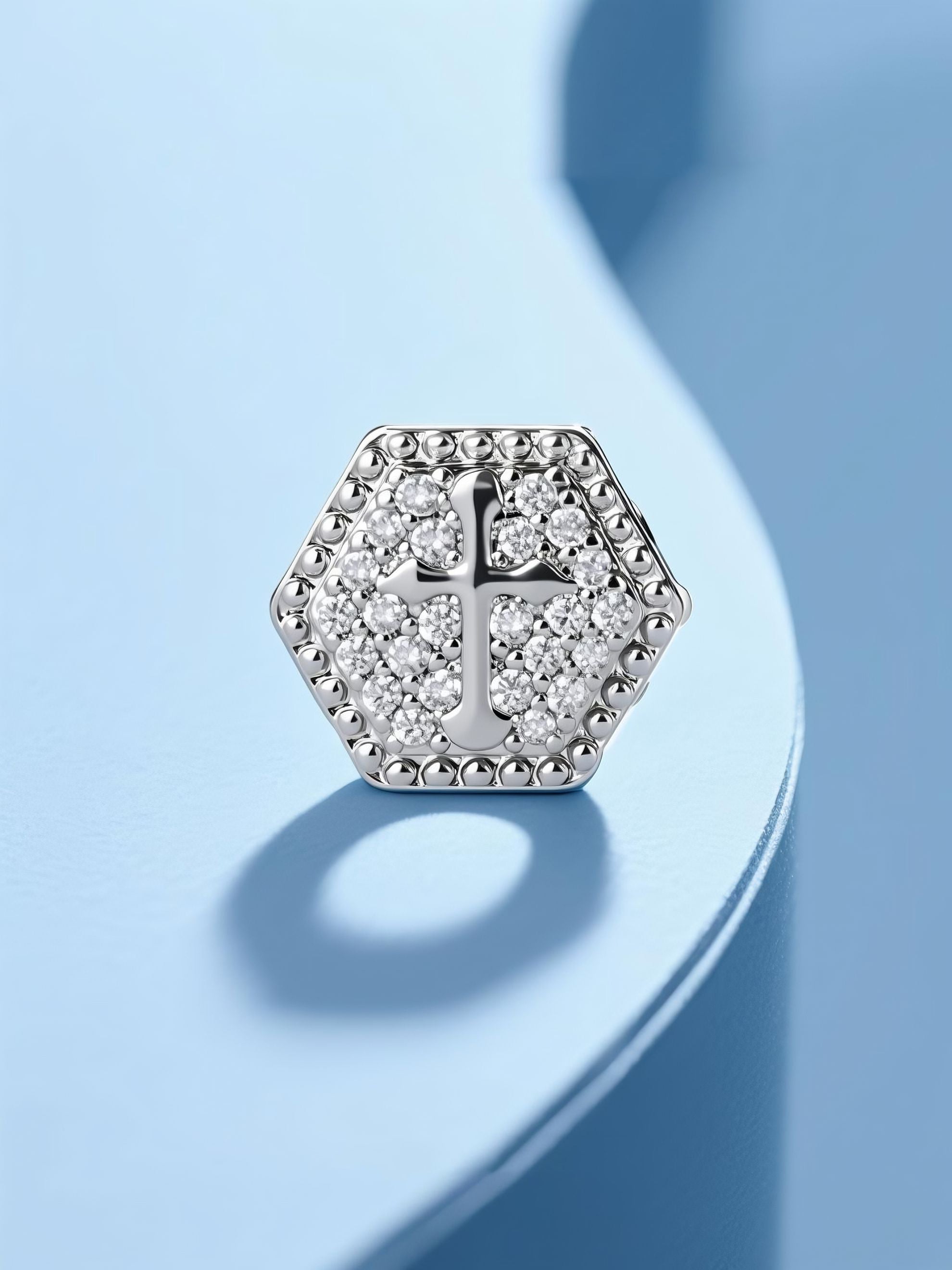 Own Your Bloom 14K cross diamond stud earrings on light blue background, shining reflection under soft studio light, Los Angeles.