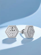 Own Your Bloom hexagonal cross diamond earrings displayed under elegant lighting, luxury jewelry presentation, Houston.