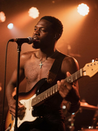 Close-up of male guitarist in Austin wearing Own Your Bloom 14K gold cross pendant necklace.