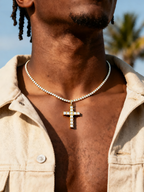 Man performing with microphone wearing the Own Your Bloom 14K diamond cross pendant, street performance scene, Atlanta.