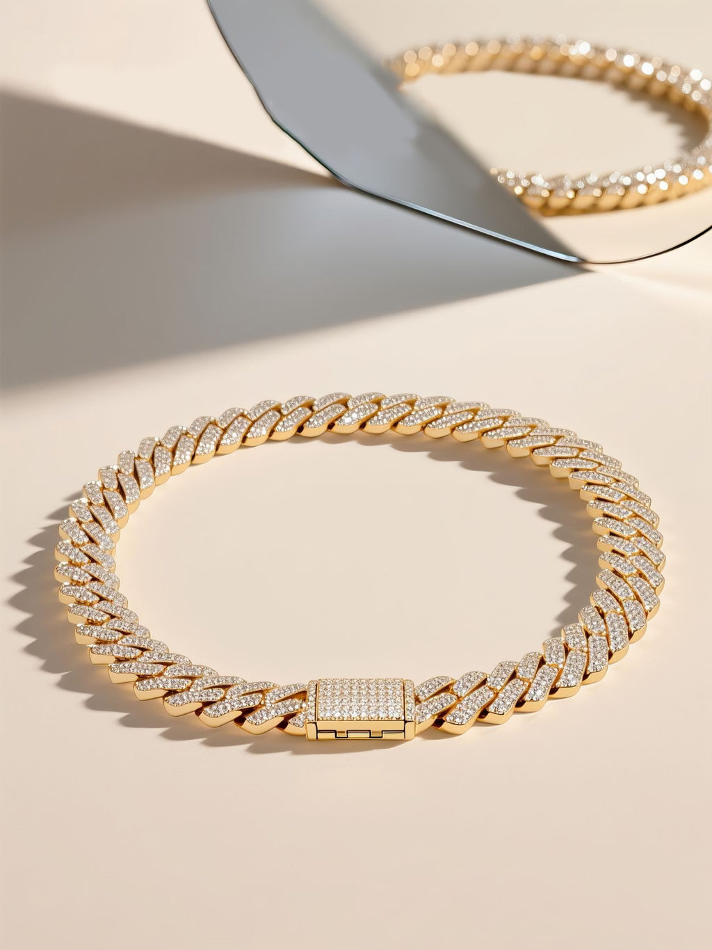 Own Your Bloom diamond Cuban chain on beige surface with mirrored luxury aesthetic, fine craftsmanship piece, Miami.