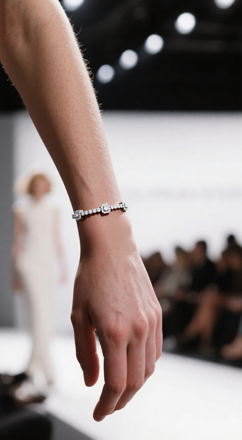 Own Your Bloom 14K diamond tennis bracelet on woman’s wrist during fashion show, refined luxury jewelry, Los Angeles.