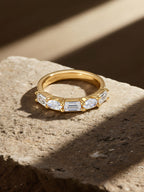 Own Your Bloom 14K yellow gold diamond ring luxury showcase with warm tone lighting and shadows, Boston.