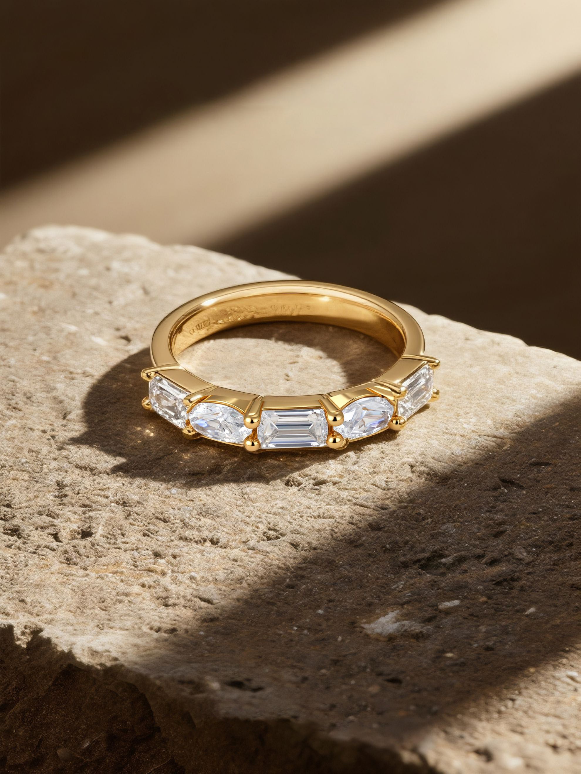 Own Your Bloom 14K yellow gold diamond ring luxury showcase with warm tone lighting and shadows, Boston.