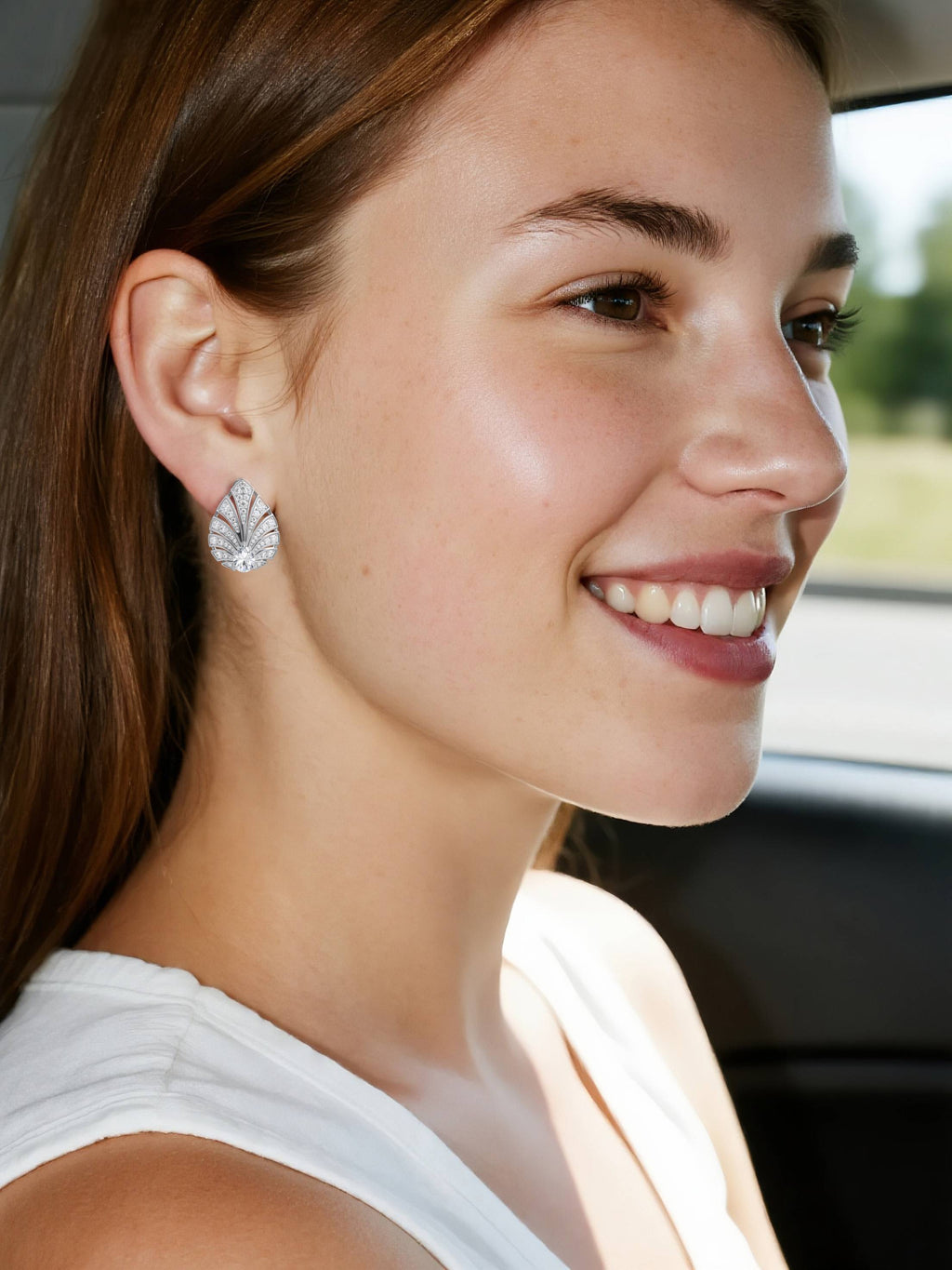 woman wearing own your bloom 14K pavé diamond fan earrings, golden-hour side profile in car, Houston TX