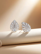own your bloom 14K white gold pavé diamond earrings displayed on pedestal edge, studio lifestyle, Miami FL