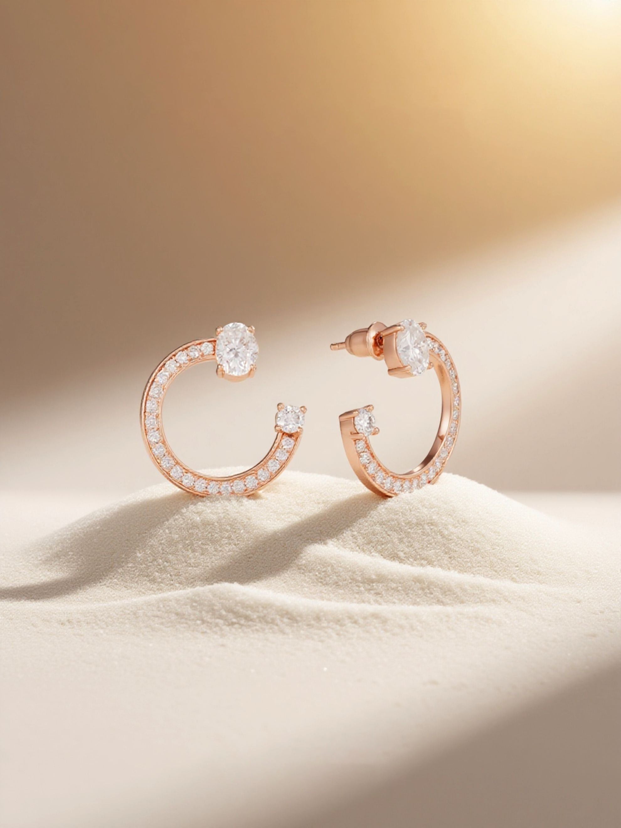 Own Your Bloom rose gold fashion earrings styled on soft sand with warm light, lifestyle scene, Los Angeles.