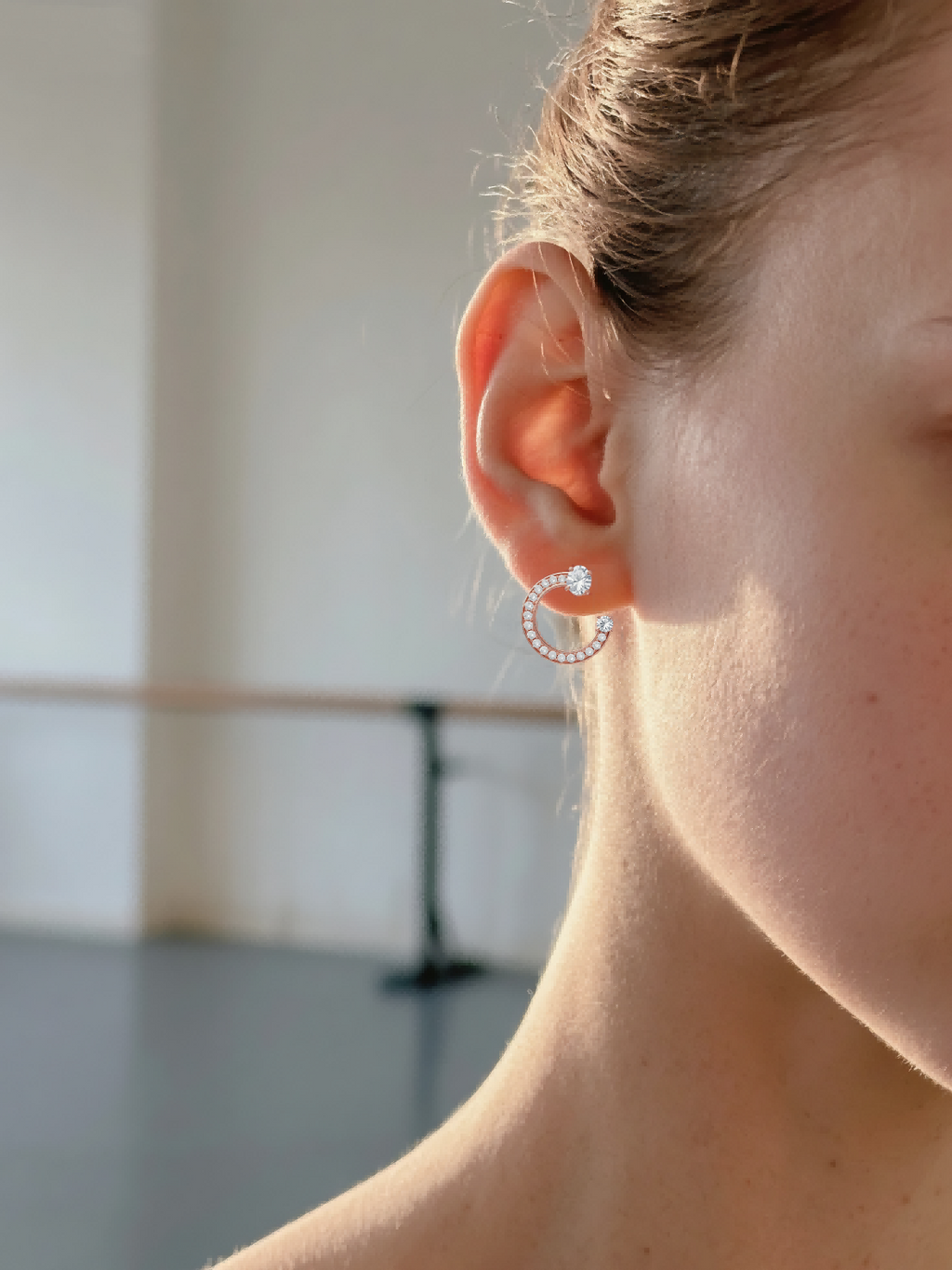 Own Your Bloom rose gold diamond fashion earrings on woman model, bright studio daylight, Houston.
