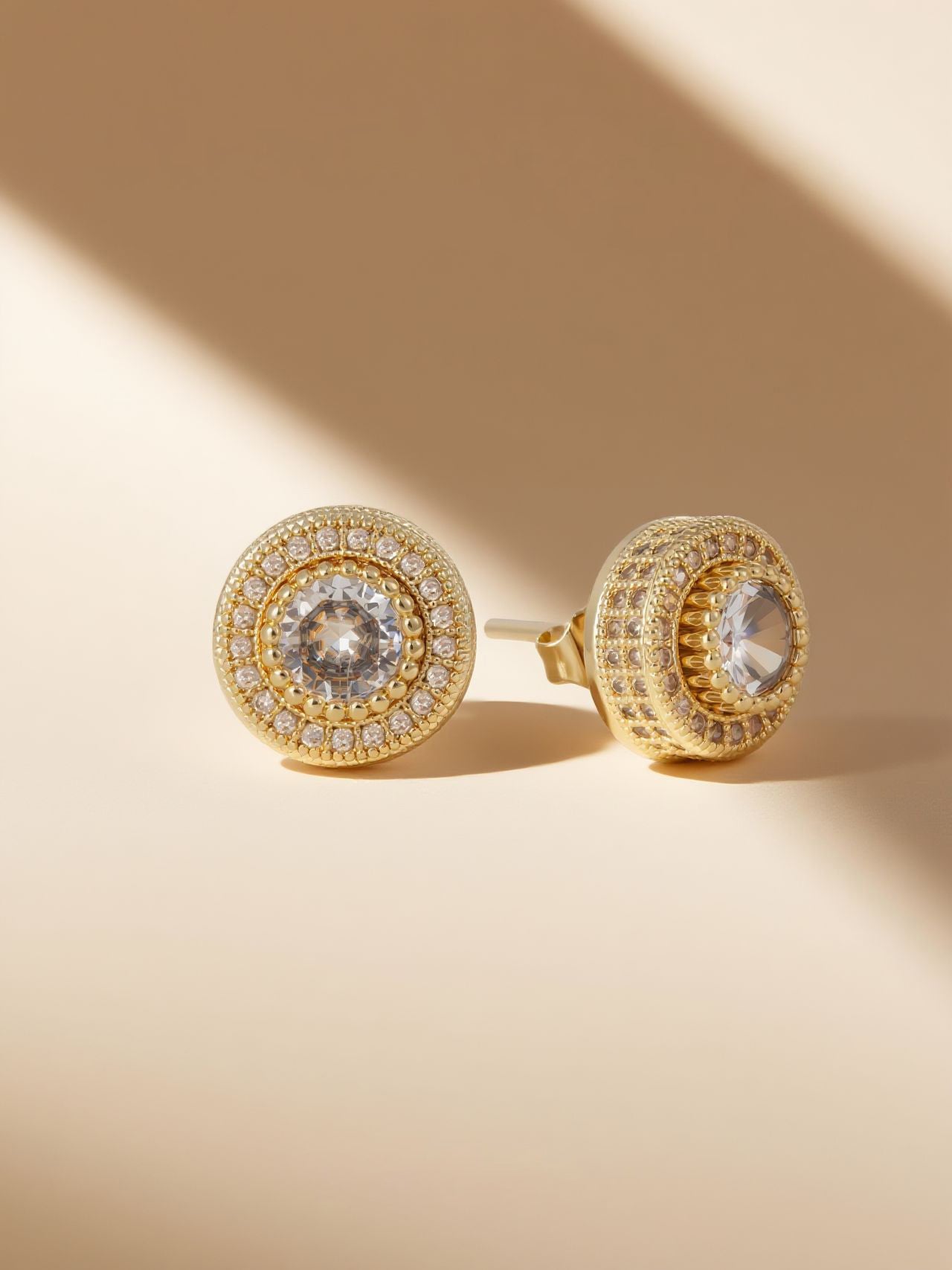 Own Your Bloom round full-gold diamond studs styled on warm sand under golden light, Southwest USA desert vibe.