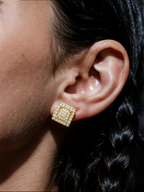 Own Your Bloom 14K gold diamond square flower earrings styled on woman in casual indoor lifestyle setting, Houston.